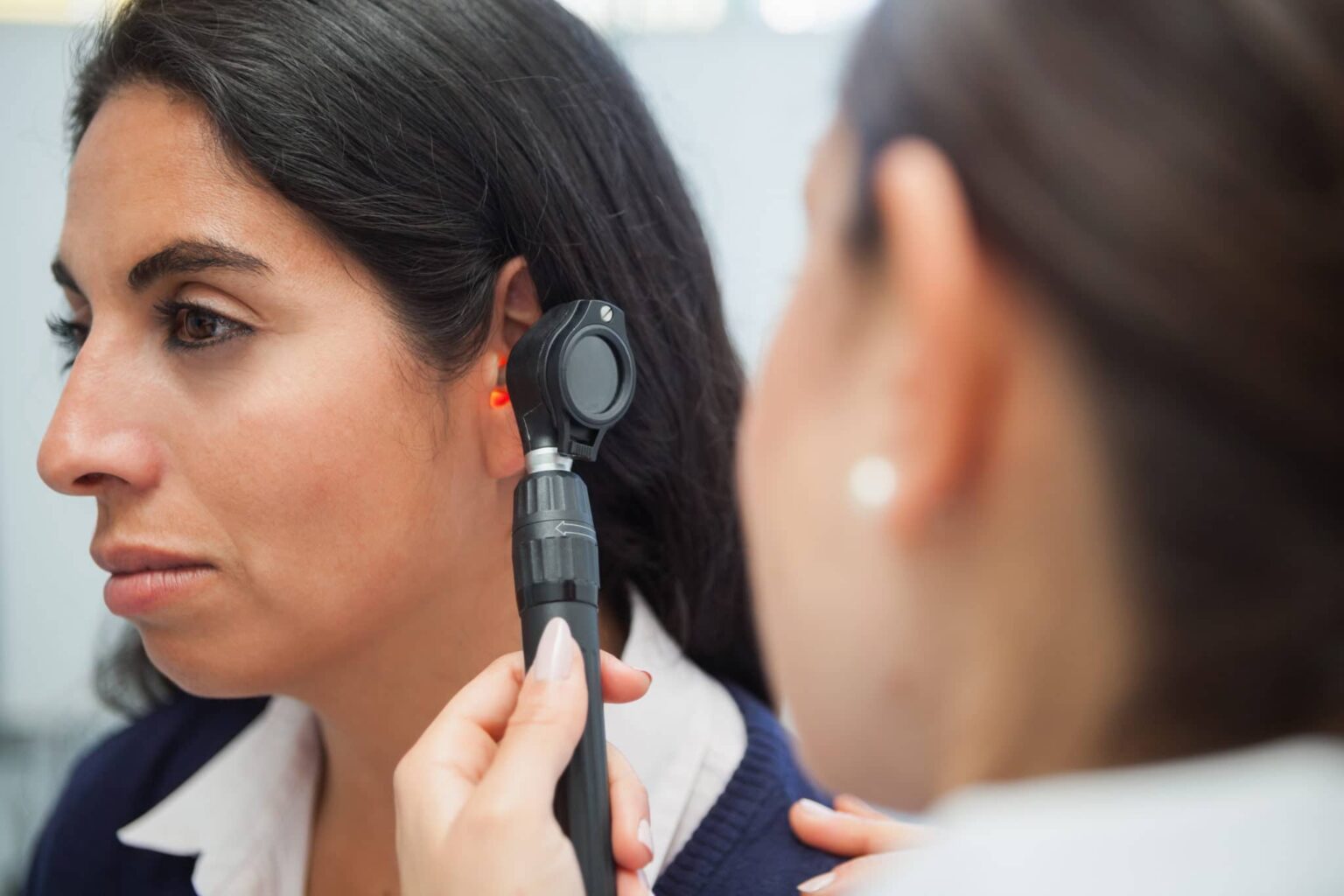 Woman getting her ears checked by an audiologist