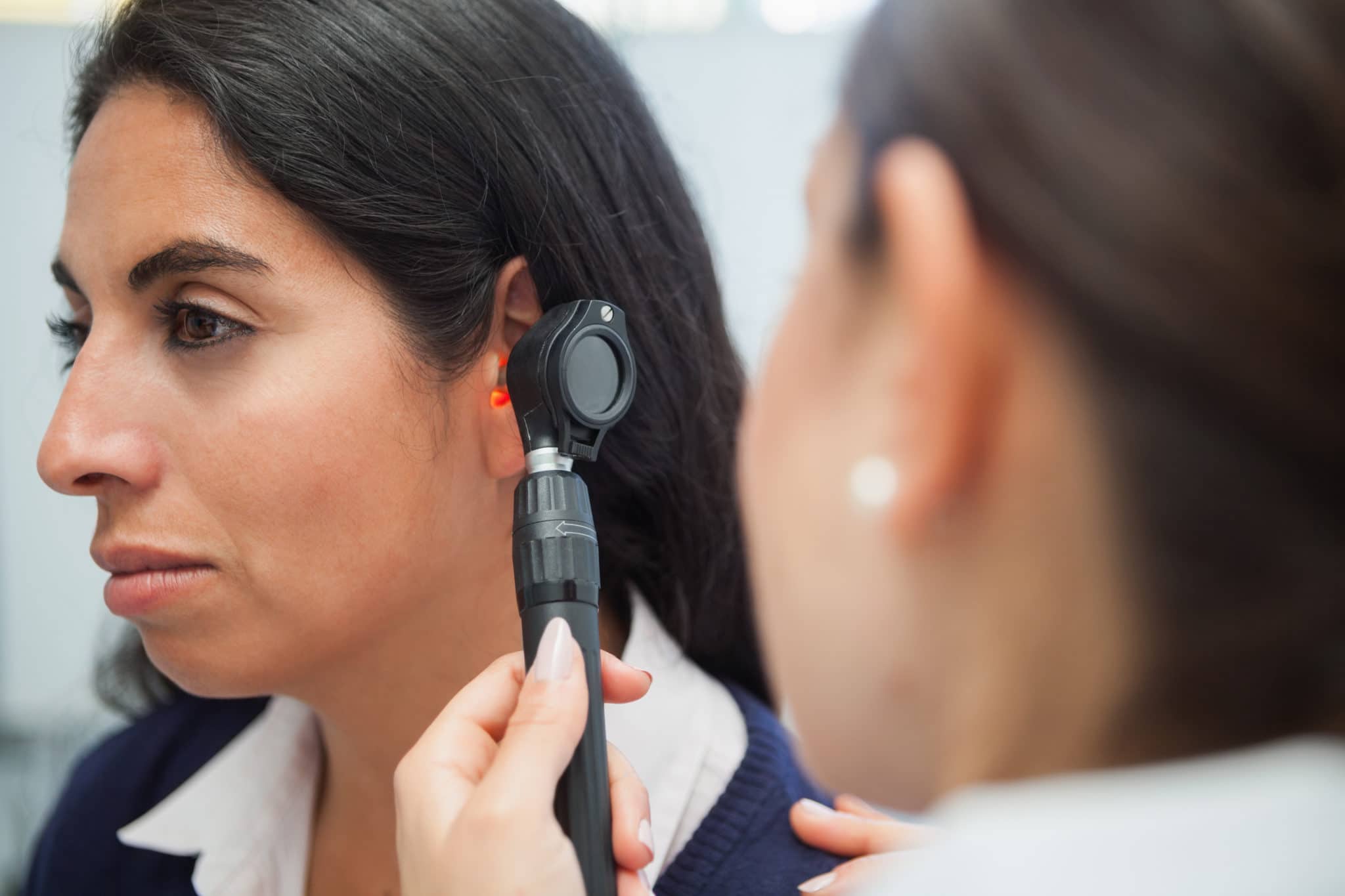 Woman getting her ears checked by an audiologist
