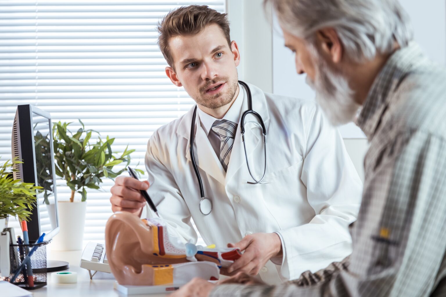 Audiologist counseling patient on hearing loss.