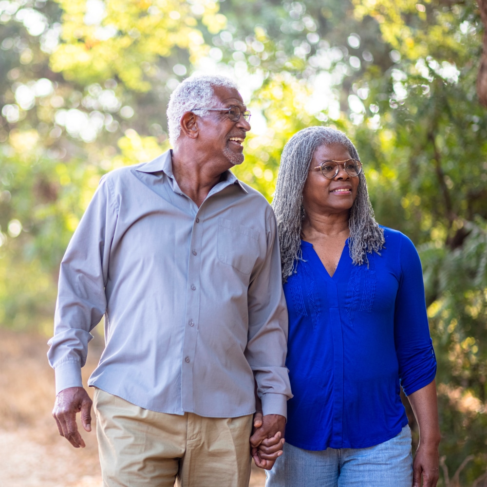 Senior Black Couple Walking on a Nature Trail a couple holds hands while walking